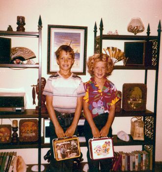 This charming vintage photo shows "Greg and Gayla", circa 1980, with their respective lunchboxes of choice - Mork and Mindy for him & Strawberry Shortcake for her.  Greg even mentioned the "Lunchbox smell"... a combination of bread and plastic.  I remember, for me, it was Capt. Kangaroo, bologna, French's mustard, and Pepperidge Farm bread!  This photo is used courtesy of Greg Mote (Thank you!) and the Creative Commons Attribution 2.0 License. (http://commons.wikimedia.org/wiki/File:Lunchbox_1980.jpg) 
